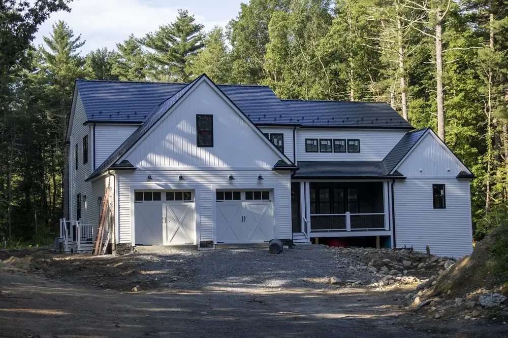 Foxborough, MA: Black Interlock Cedar Shingle Metal Roof on a Board-and-Batten House